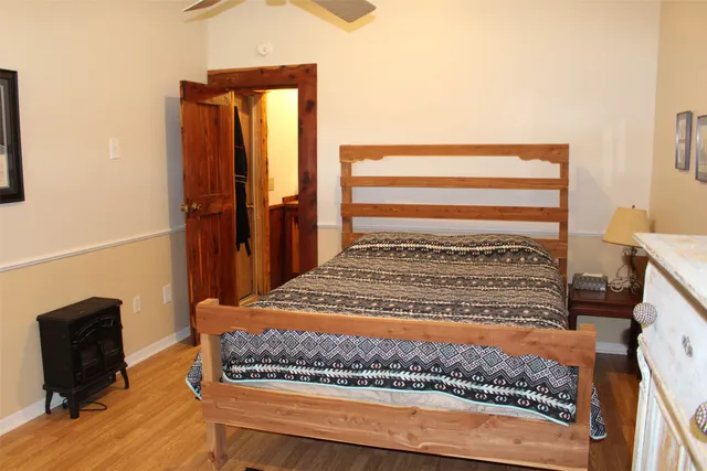 a bedroom with a bed and dresser with mirror