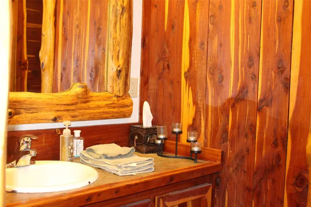 a bathroom with a toilet and a mirror