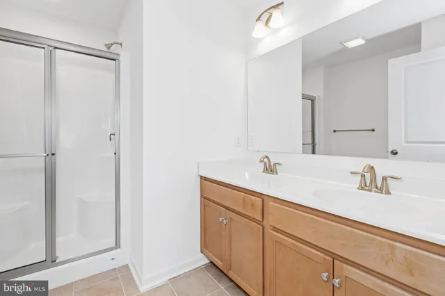 a bathroom with a double vanity sink and mirror