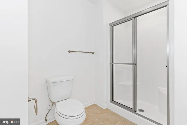 a white toilet sitting next to a bathroom sink