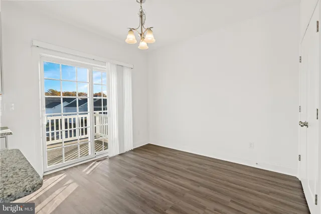 a view of a livingroom with wooden floor and a window