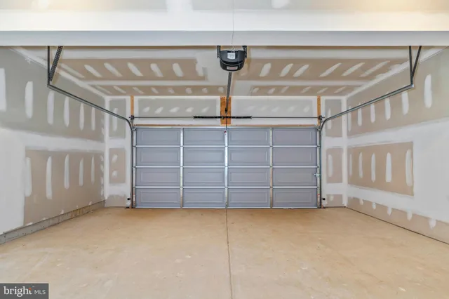 a view of an empty room with cabinet and mirrors