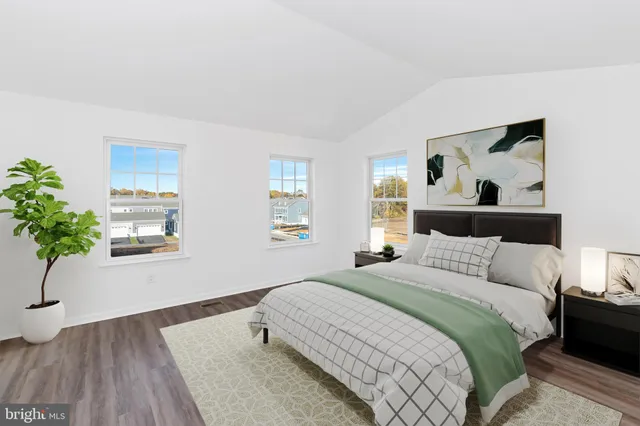 a bedroom with a bed and a potted plant