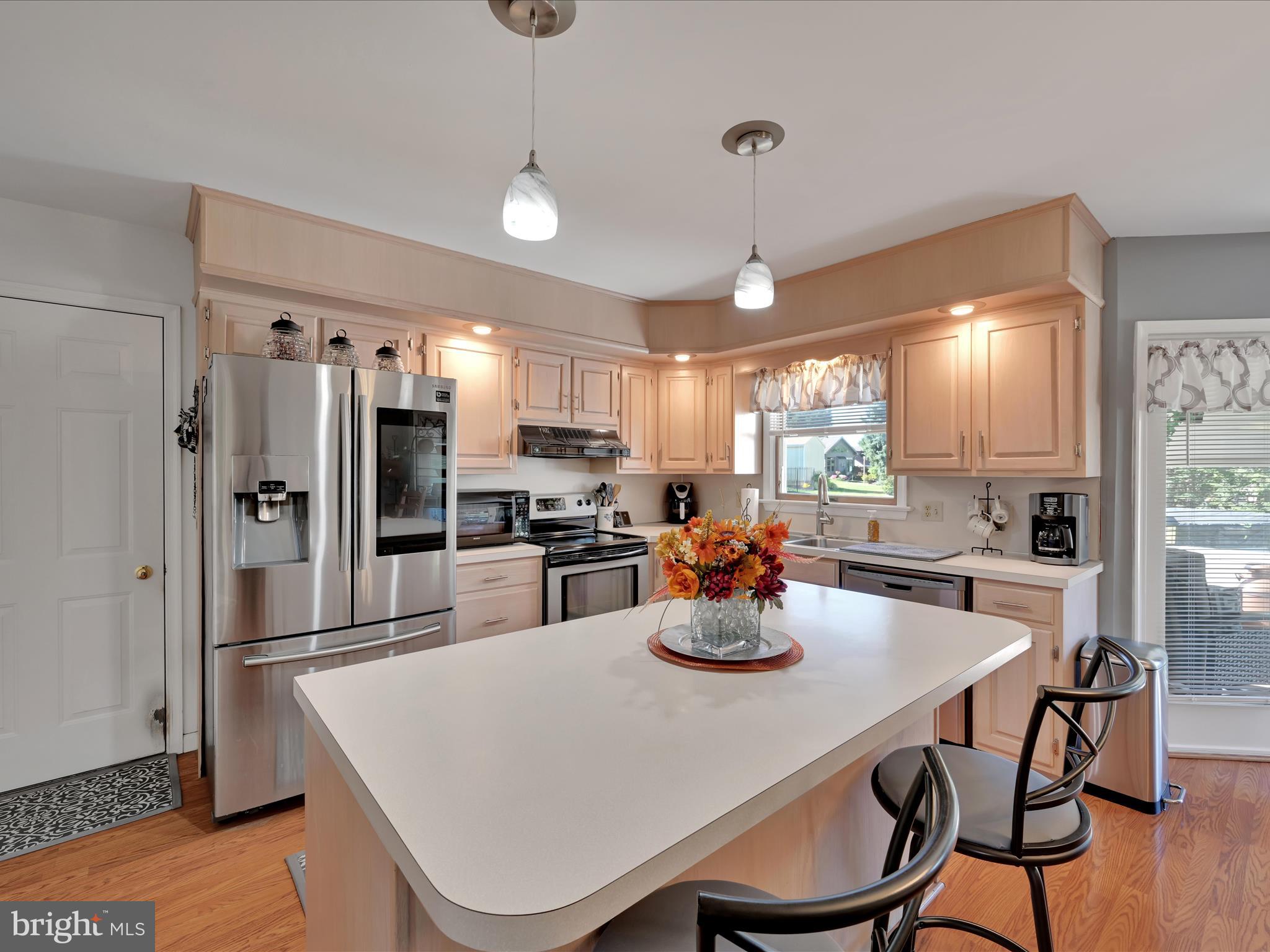 9 Palm Lane Lebanon, PA 17042 - Photo 8 of 32 a kitchen with a dining table cabinets appliances and wooden floor