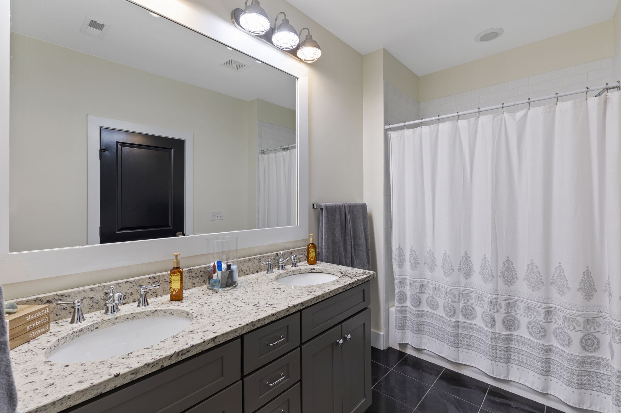 3209 Kinross Avenue Nashville, TN 37211 - Photo 32 of 48 a bathroom with a granite countertop sink and a mirror