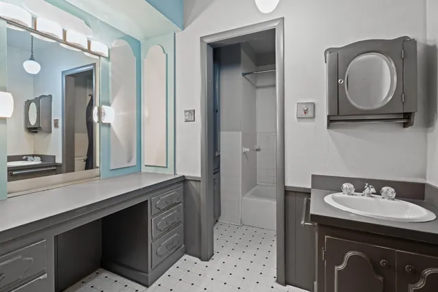 a bathroom with a sink and a mirror