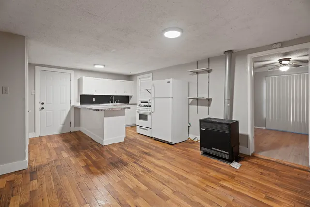a kitchen with white cabinets and stainless steel appliances