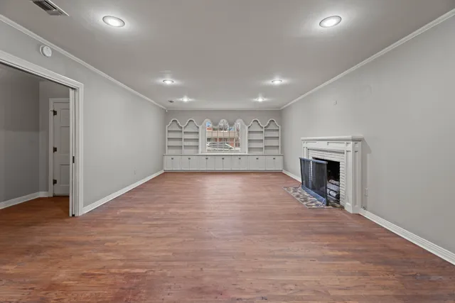 wooden floor in an empty room with a fireplace