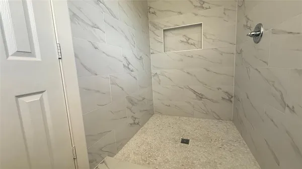 a bathroom with a toilet a sink a window and mirror
