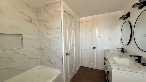 a bathroom with a sink and mirror with toilet