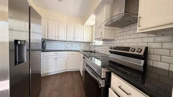 a kitchen with a sink stove and cabinets