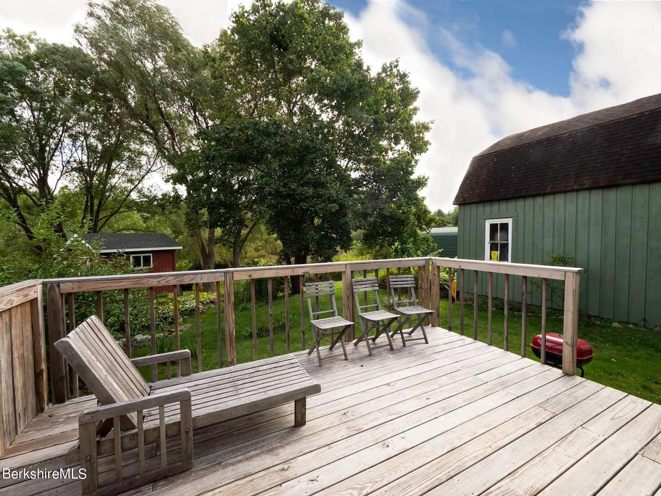 33 South Main Road Otis, MA 01253 - Photo 14 of 15 a view of a deck with chairs a barbeque with wooden floor and fence