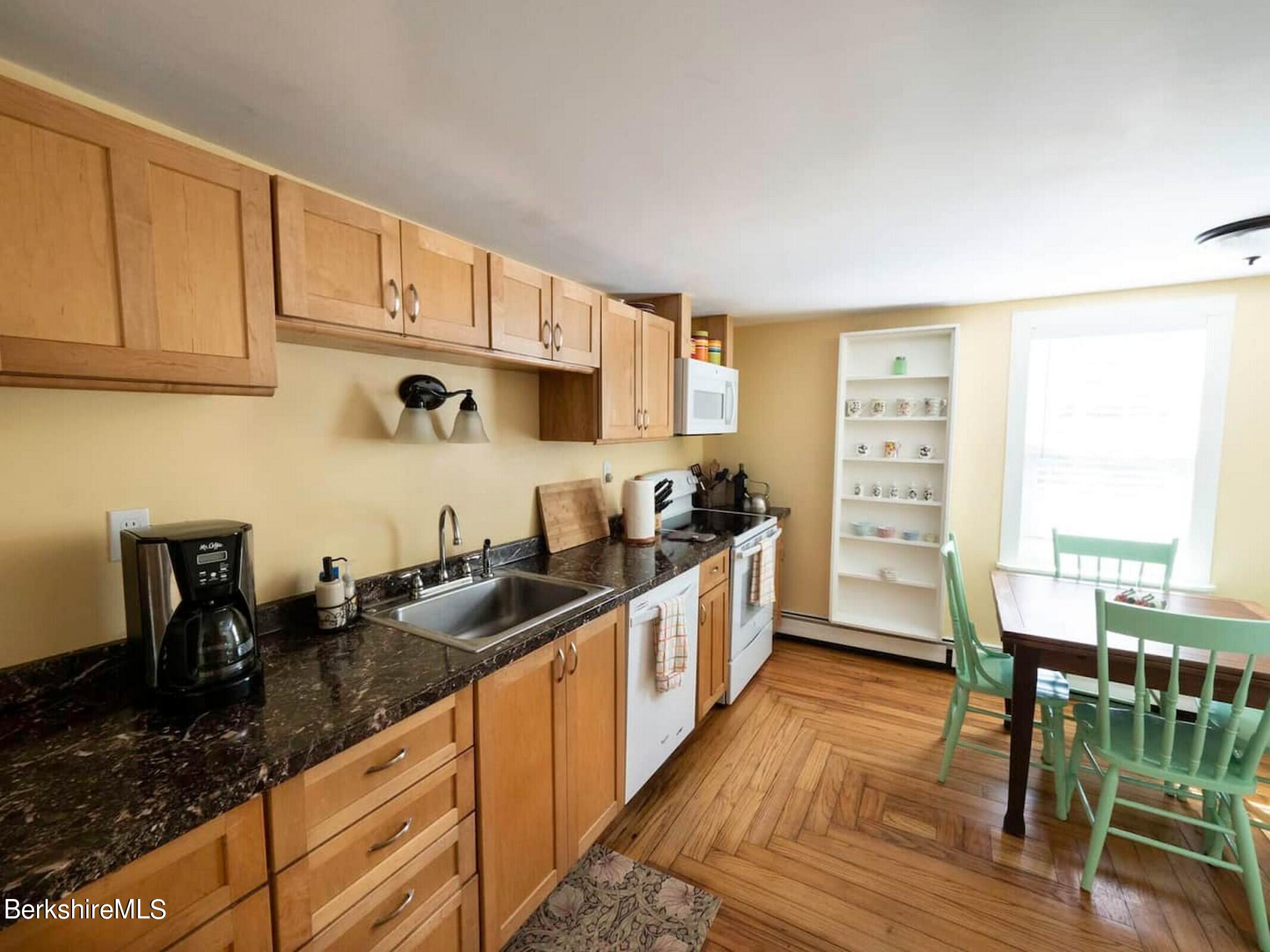 33 South Main Road Otis, MA 01253 - Photo 7 of 15 a kitchen with granite countertop a sink stove and cabinets