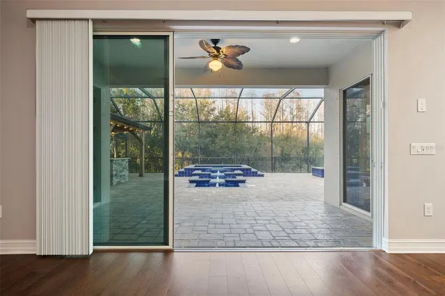 a kitchen with stainless steel appliances granite countertop a sink a stove a refrigerator and island with wooden floor