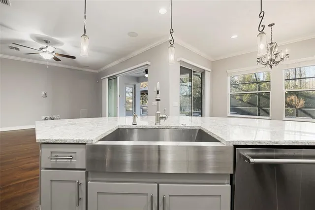 a view of a kitchen with wooden floor and a window