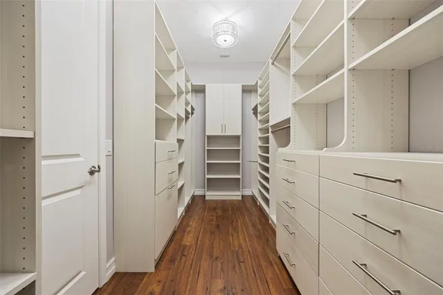 a view of walk in closet with empty racks