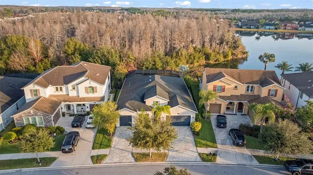 an aerial view of multiple houses with a lake view