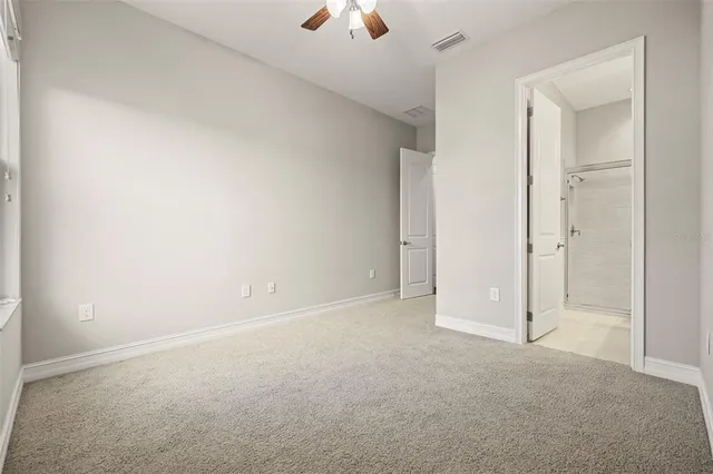 a bathroom with a granite countertop sink toilet a mirror and shower