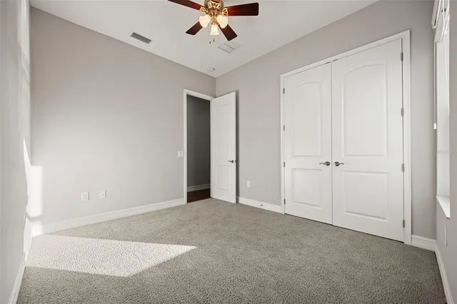a bathroom with a granite countertop sink a toilet and bathtub