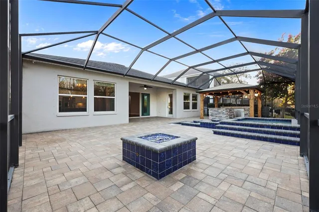 an aerial view of a house with outdoor space and a lake view