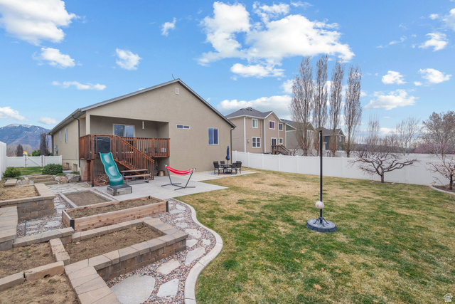1896 West 800 North Mapleton, UT 84663 - Photo 39 of 55 Back of house with a patio, a fenced backyard, a garden, and a mountain view