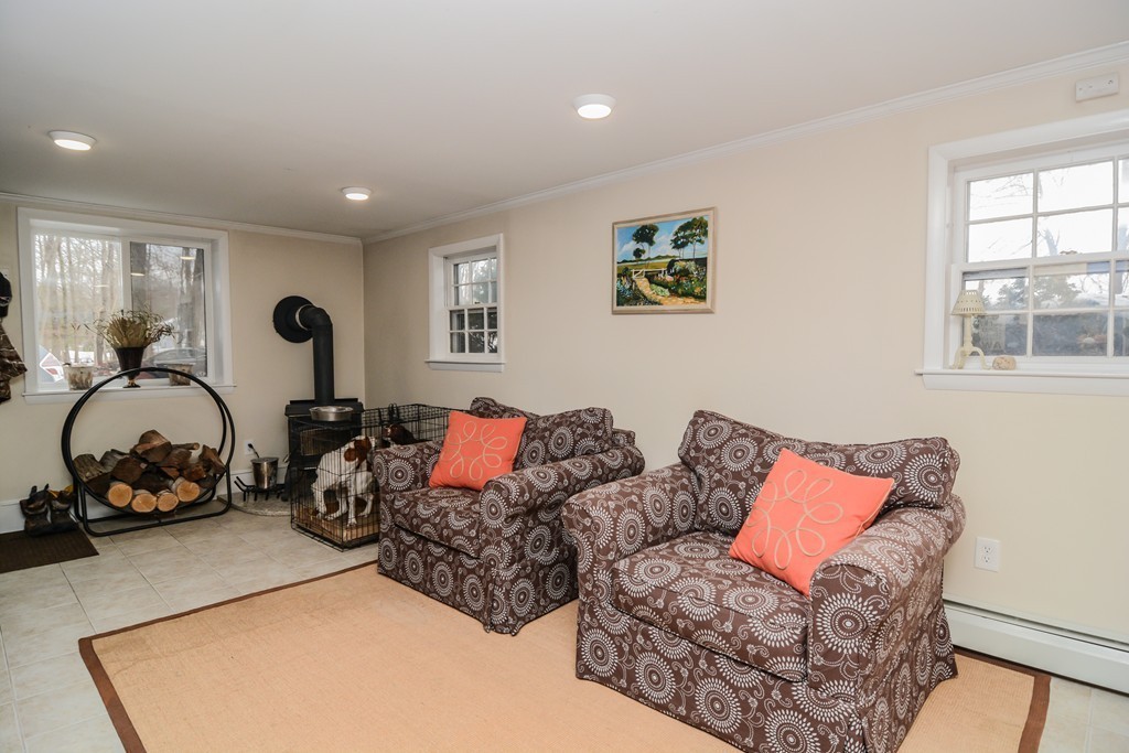 199 Center Bridge Road Lancaster, MA 01523 - Photo 27 of 30 a living room with furniture a window and gym cycle