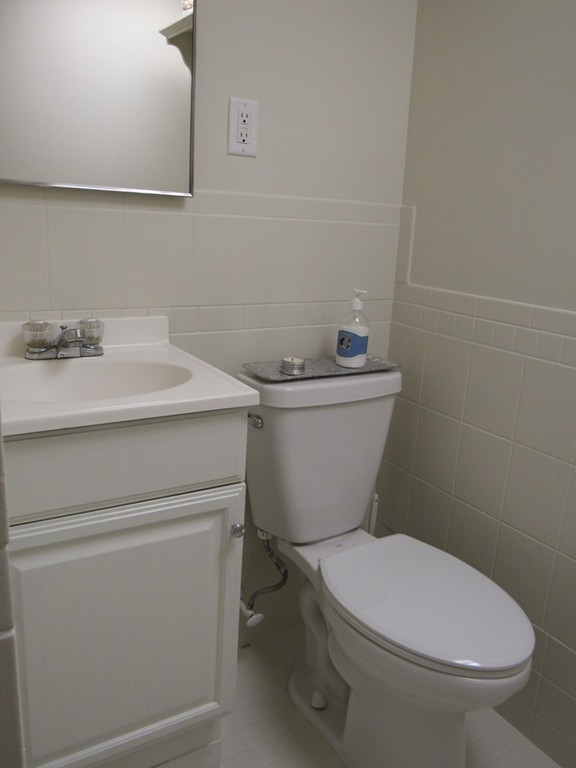 199 Center Bridge Road Lancaster, MA 01523 - Photo 29 of 30 a white toilet sitting next to a bathroom sink