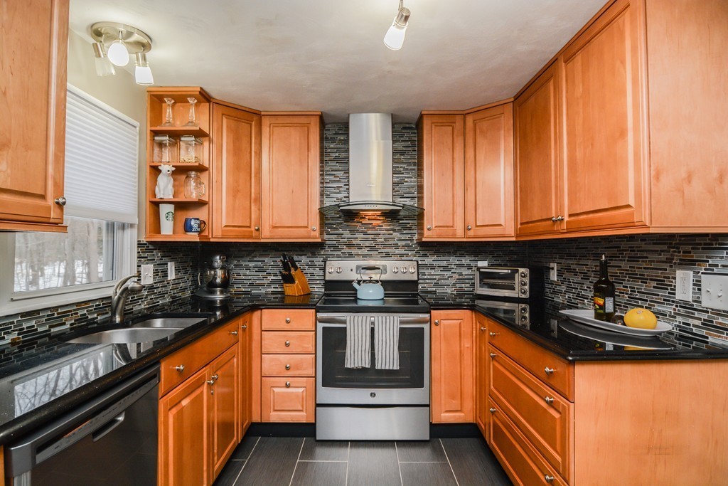 199 Center Bridge Road Lancaster, MA 01523 - Photo 5 of 30 a kitchen with stainless steel appliances granite countertop a stove a sink and a microwave