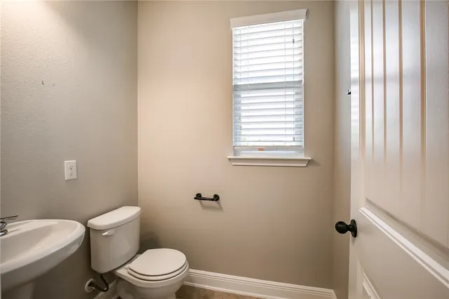 a white toilet sitting next to a bathroom sink