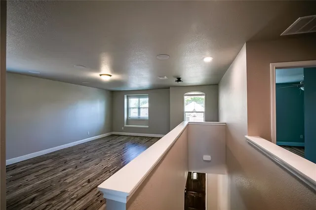 a view of a hallway with windows