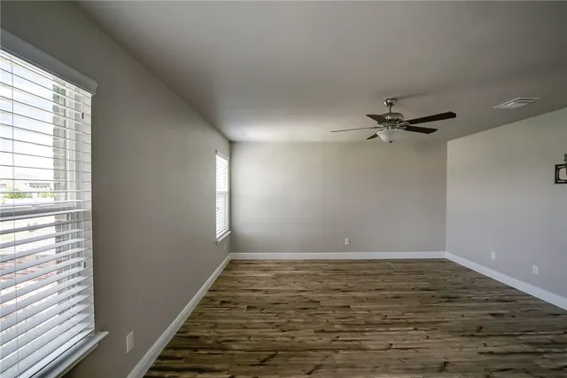 a view of a room with wooden floor and window