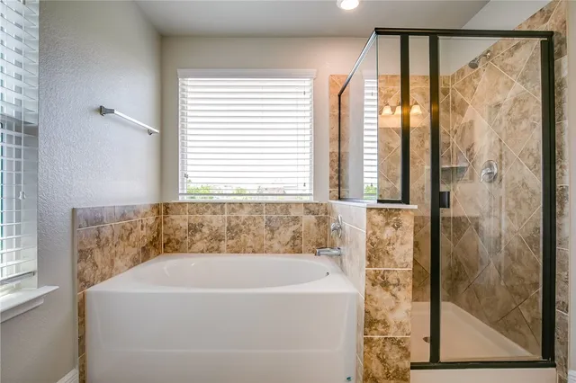 a white bath tub sitting next to a window