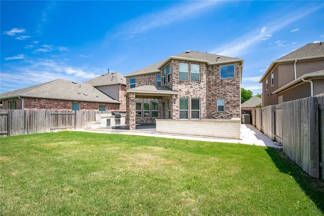 a view of a house with a yard deck and sitting area