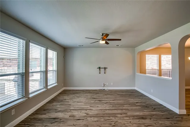 wooden floor in an empty room with a window