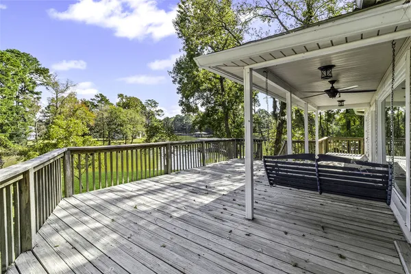 a view of a wooden deck with a yard