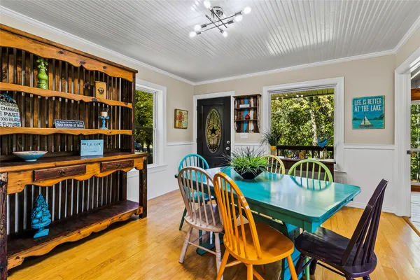 a dining room with furniture and a book shelf