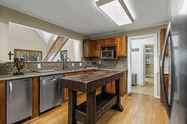 a kitchen with a sink stove and refrigerator