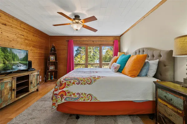 a bedroom with a bed and a flat screen tv