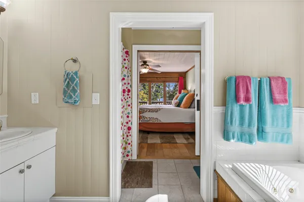 a living room with a bed and a dresser next to a window