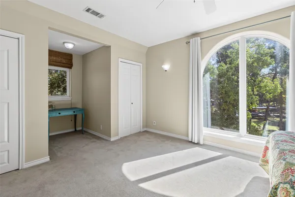 an empty room with windows and closet