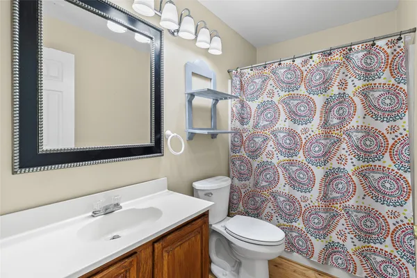 a bathroom with a sink and mirror with toilet