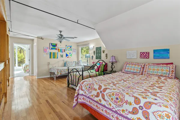 a bedroom with a bed a couch and a window