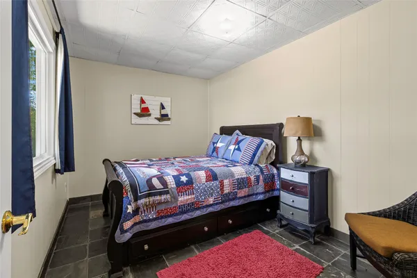 a bed room with a bed and a chair