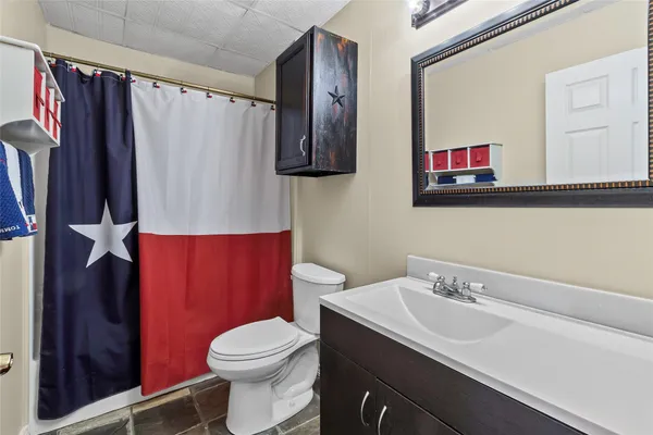 a bathroom with a toilet a sink and a mirror