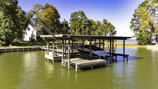a view of a lake with lawn chairs