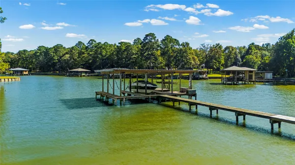 a view of a lake in between two trees