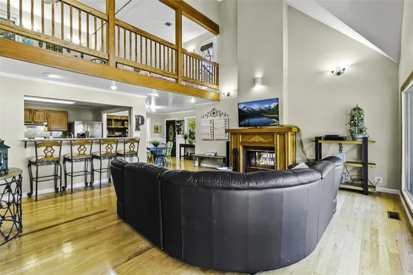 a living room with fireplace furniture and a wooden floor