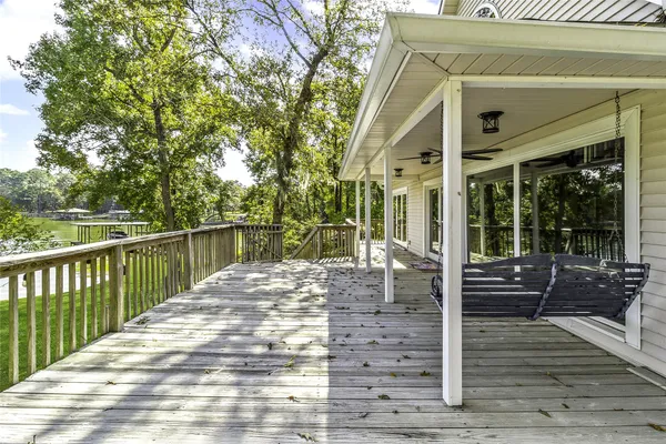 a view of a house with backyard porch and sitting area