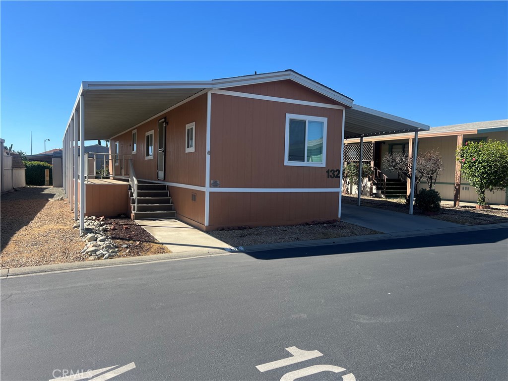 a front view of house with yard outdoor seating and barbeque