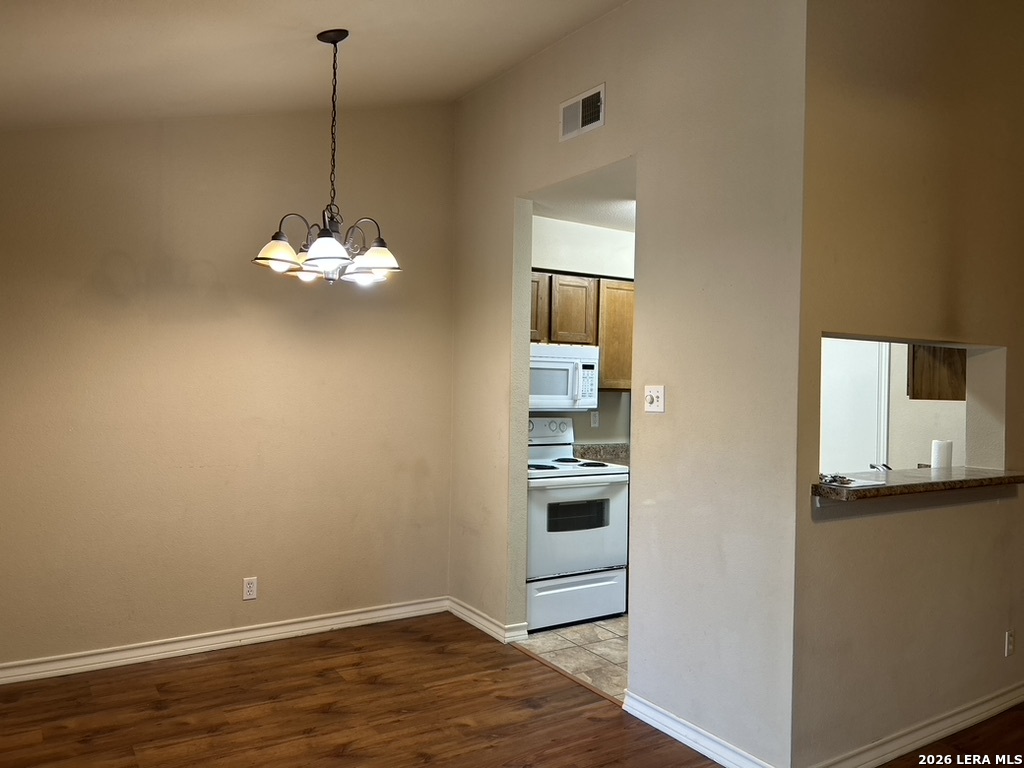 13018 Heimer Road, Unit 710 San Antonio, TX 78216 - Photo 7 of 27 a view of a kitchen with a sink cabinets and wooden floor